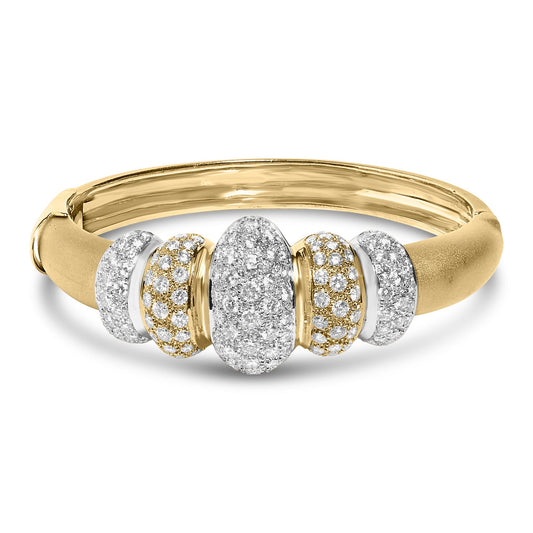 Close-up front angled shot of a yellow and white metal bracelet featuring five oval and rounded sections paved with numerous small white gemstones.