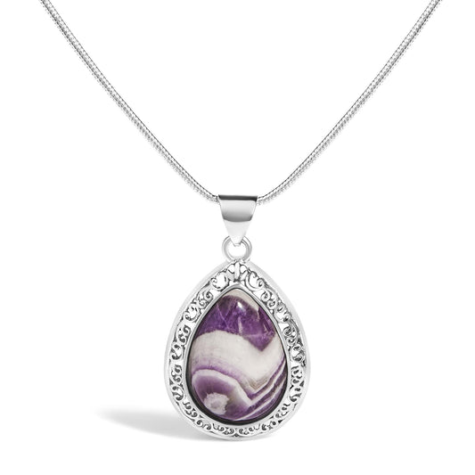 Close-up front view of a white necklace with a pear-shaped purple gemstone pendant in a bezel setting, featuring an ornate filigree border.
