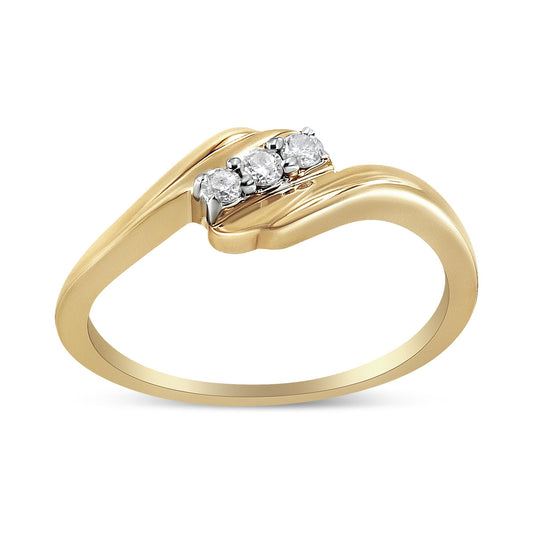 Yellow metal ring with three round white gemstones in prong setting, shown at an angle.