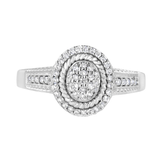 Front-facing close-up of a white metal ring with round white gemstones in a pave setting on the top and along the band.