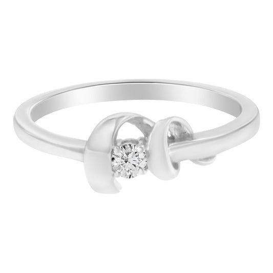 White metal ring with a round white gemstone in prong setting, shown in a front angle close-up.