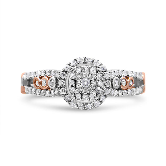 Front view of a white and rose metal ring featuring a central round gemstone in a miracle setting surrounded by multiple smaller round white gemstones in prong settings on the band.