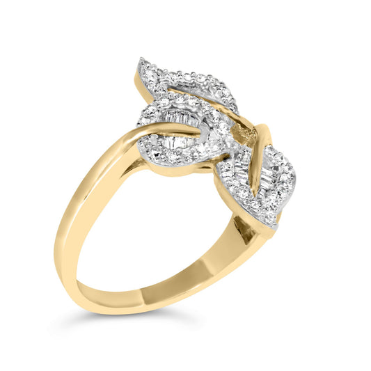 Angled close-up of yellow metal ring with intertwined design featuring white round and baguette-shaped gemstones in pave and channel settings.