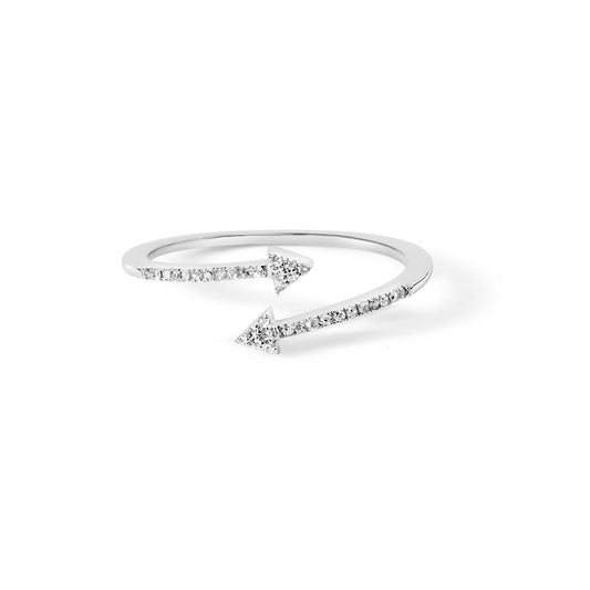 White metal open band ring with two arrowhead ends studded with white round gemstones, shown from a slightly angled top view.