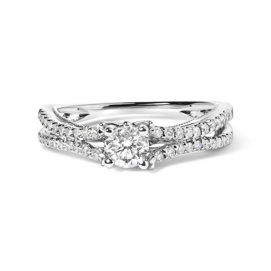 White metal ring set with a round white gemstone in a four-prong setting and two bands of smaller round white gemstones in shared prong settings, shown in a front close-up angle.