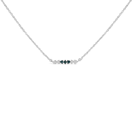 Front view of a white metal necklace with a horizontal row of round-shaped gemstones; three blue gemstones in prong settings are centered, flanked by four white gemstones in pave settings, shown on a white background.