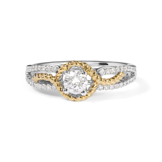 Front view of a yellow and white metal ring with a round white gemstone in a 4-prong setting encircled by twisted yellow metal and intersecting bands of round white gemstones in shared prong settings.