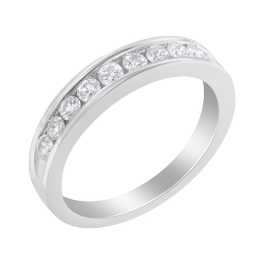 White metal ring with channel-set round white gemstones, shown at an angled top view.