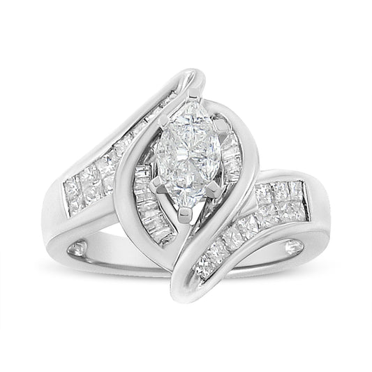 Close-up front angle of a white metal ring featuring a central pie-shaped white gemstone in a prong setting, surrounded by baguette and princess-shaped white gemstones in channel settings on the split band.