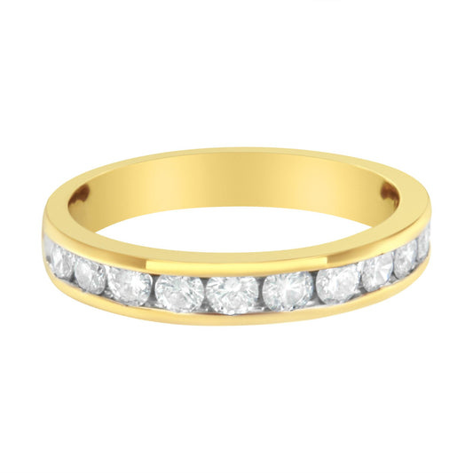 Yellow metal ring with channel set round white gemstones, viewed from a slightly angled front perspective.