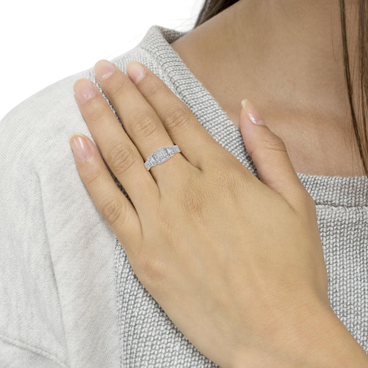 White metal ring with a center rectangular gemstone, two smaller rectangular gemstones on each side, and multiple small round gemstones along the band, worn on a model’s finger, front angle.