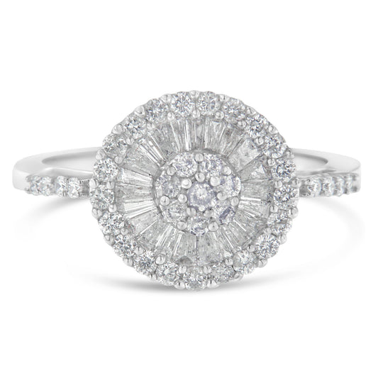 Front-facing close-up of a white metal ring featuring a central round-shaped gemstone in prong setting, surrounded by a halo of baguette-shaped gemstones in channel setting and an outer circle of round-shaped gemstones in prong setting, with additional round-shaped gemstones set along the band.
