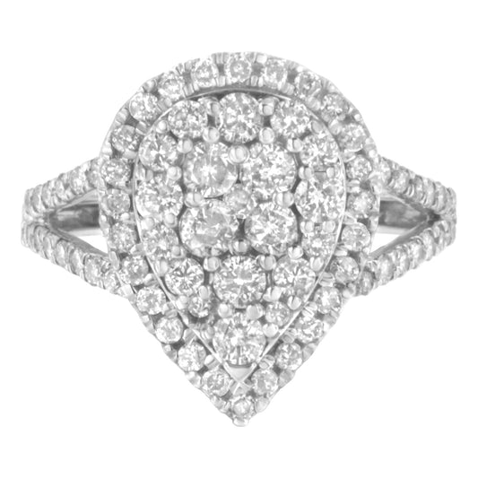Front-facing view of a white metal ring with a pear-shaped cluster of round white gemstones in prong settings, with additional round white gemstones set along the split shank.