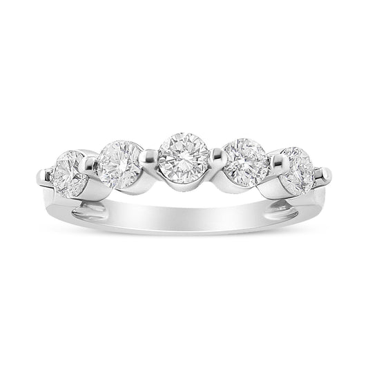 White metal ring with five round white gemstones in pave setting, shown in a close-up front angle.
