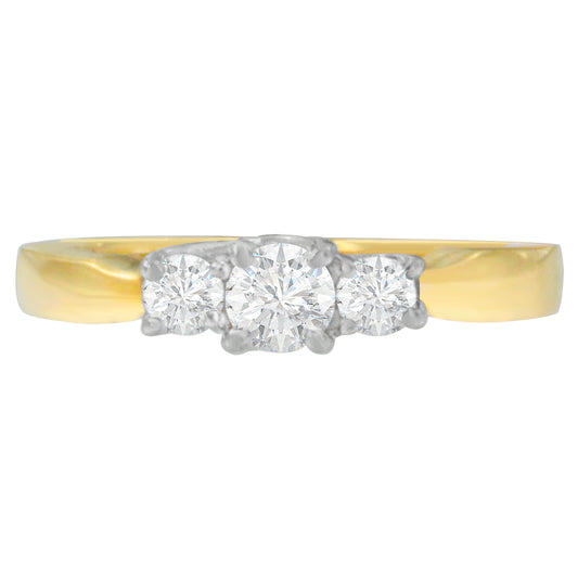 Front view of a two-toned ring with three round white gemstones in prong settings.