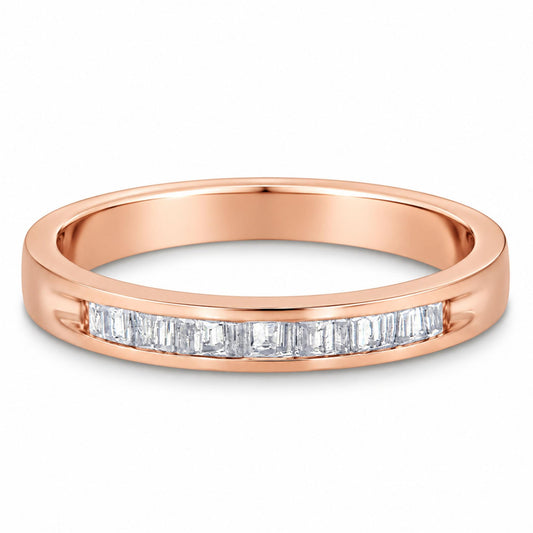 Close-up front angle of a rose-colored ring featuring a channel setting of white baguette-shaped gemstones.