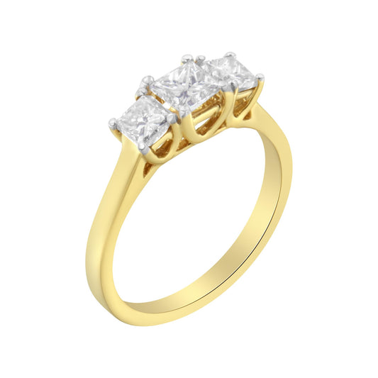 Yellow metal ring with three white princess-shaped gemstones in prong settings, viewed from a front-side angle.