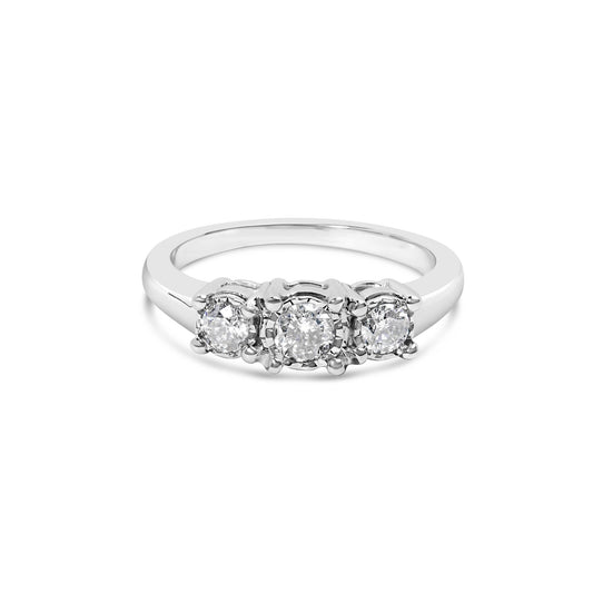 Front angle view of a white metal ring with three round white gemstones in miracle settings.