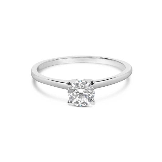 White metal ring with a round white gemstone in a 4-prong setting, shown from the front angle.