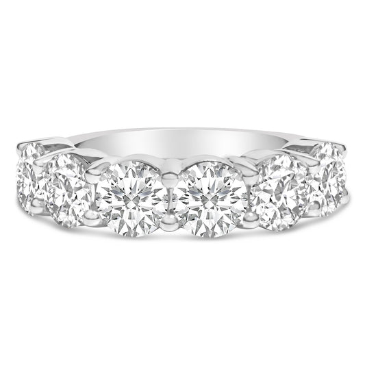 Close-up front view of a white ring featuring a row of round white gemstones set in a shared prong setting.