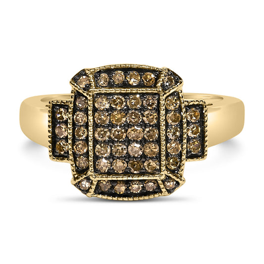 Front-facing shot of a yellow ring with a square cluster of round champagne-colored gemstones in prong settings, accented by additional gemstones on the sides.