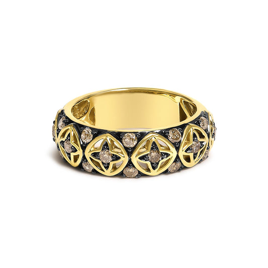 Close-up front view of a yellow metal ring featuring a pattern of open shapes accented with prong-set round champagne-colored gemstones.