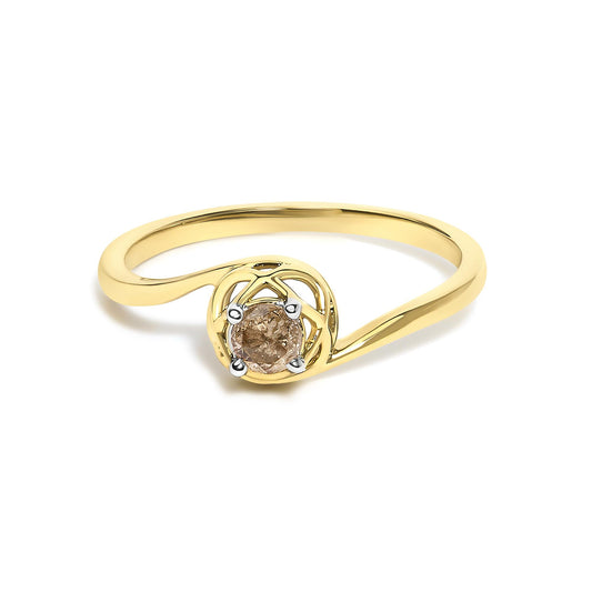 Close-up front angle of a yellow metal ring with a round, white gemstone in a prong setting, shown on a white background.