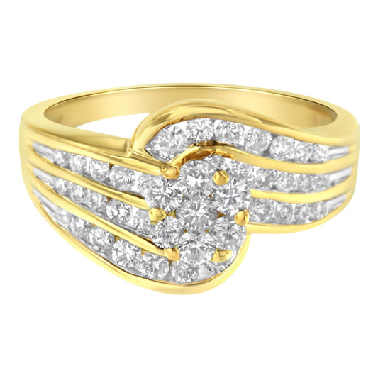 Close-up front angle of a yellow ring featuring multiple round white gemstones in a channel setting forming a swirling design.