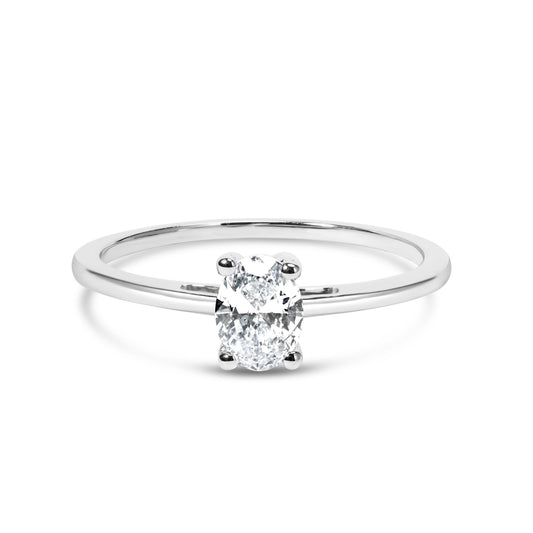 White metal ring with an oval white gemstone in a four-prong setting, shown in a front angle close-up.