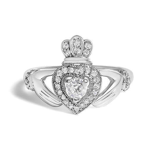 Close-up front angle of a white metal ring featuring a heart-shaped center with a round white gemstone, surrounded by smaller round white gemstones and topped with three decorative elements also set with round white gemstones. The band includes additional round white gemstones on each side.