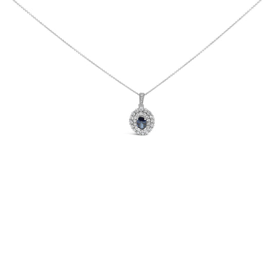 White metal necklace with oval blue gemstone pendant surrounded by round white gemstones, shown in a front-facing close-up angle.