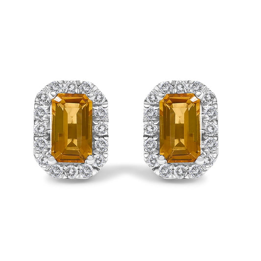 Front view of white metal rectangular stud earrings with orange gemstones in the center surrounded by a halo of small white gemstones.