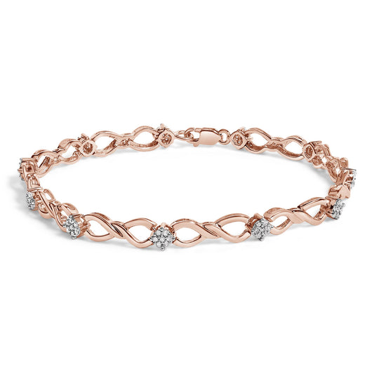 Rose metal bracelet with intertwined design and round white gemstones in a pave setting, shown from a front angled view.
