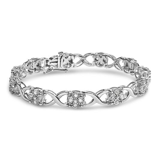 White metal bracelet with interlocking curved links and clusters of round white gemstones in prong settings, shown from a slightly elevated front angle.