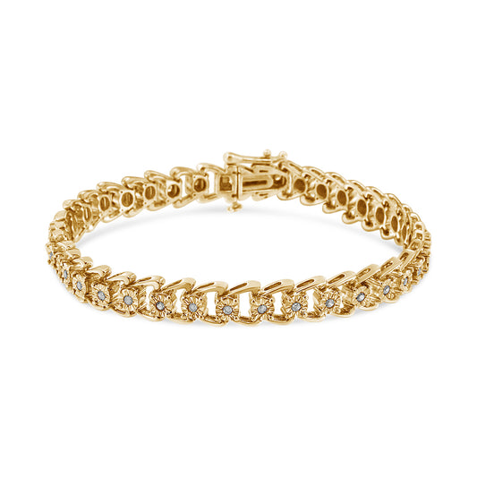 Yellow metal bracelet with round white gemstones in miracle setting, displayed at a slight angle on a white background.