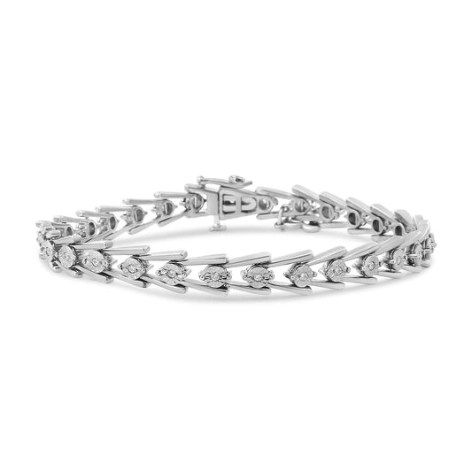 White metal bracelet with round white gemstones in miracle setting, shown from a side angle on a white background.