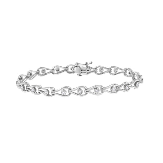 White metal bracelet with round white gemstones in a miracle setting, shown in a flat lay front angle.