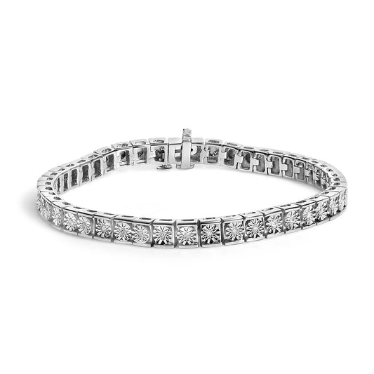 Close-up front angle of white metal bracelet with round white gemstones set in square links.