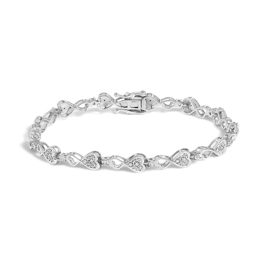 White bracelet with heart-shaped links accented with round white gemstones, shown in a close-up angled front view.