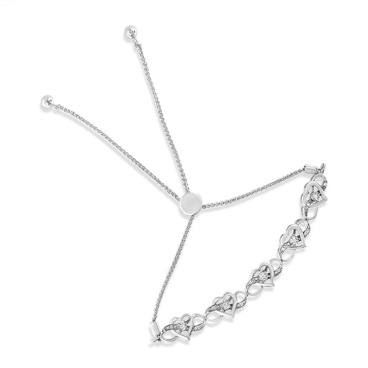 White metal bracelet with heart-shaped links featuring round white gemstones in miracle settings, shown from a top angle.
