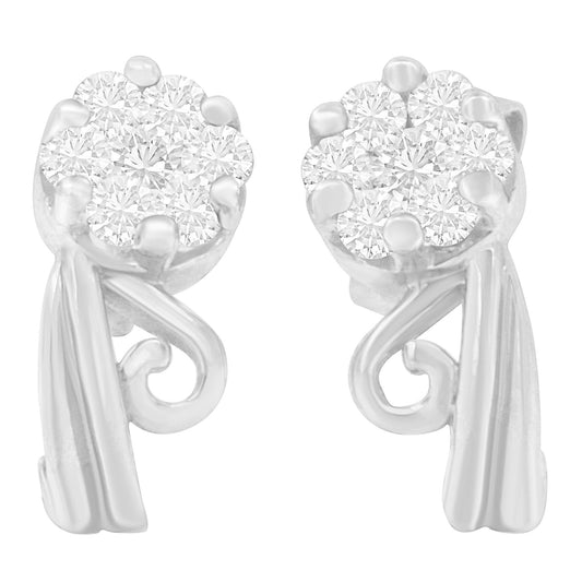 Front-facing close-up of white metal earrings with clustered round white gemstones in prong settings and decorative scroll details.