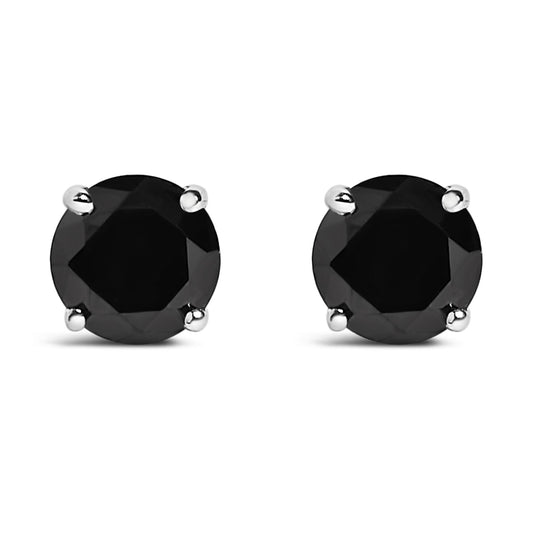 Close-up front view of a pair of white metal stud earrings featuring round black gemstones set in four-prong settings against a white background.