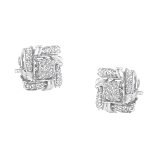 Pair of white metal earrings viewed from a front angle, featuring a woven design with round-shaped white gemstones in prong settings and square-shaped white gemstones in invisible settings.