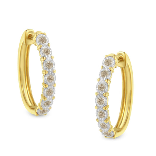 Close-up front-angle view of two-toned earrings with a row of round white gemstones in miracle settings along the outer edge.