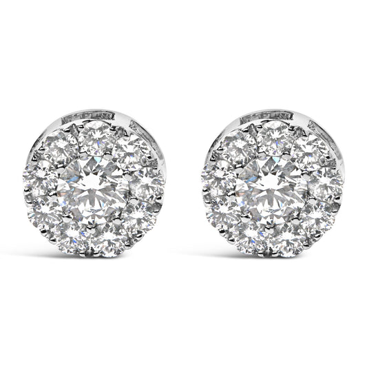 Close-up front view of a pair of round white metal earrings featuring a large central round white gemstone surrounded by smaller round white gemstones in a prong setting.