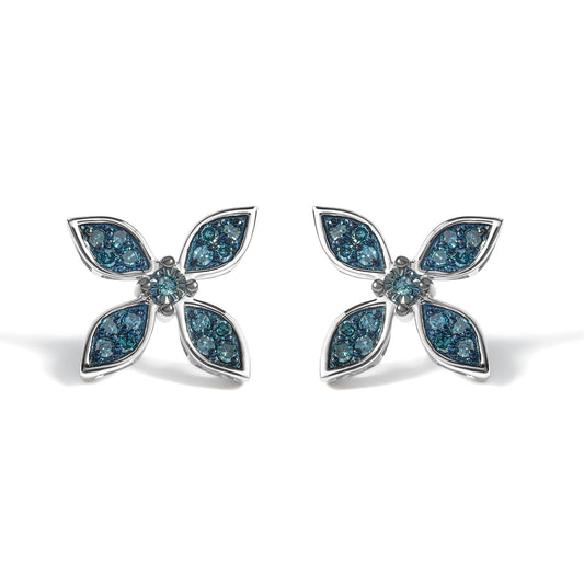 Close-up front view of a pair of white metal earrings shaped like flowers with four petal-like sections containing blue round gemstones in prong settings, shown on a white background.