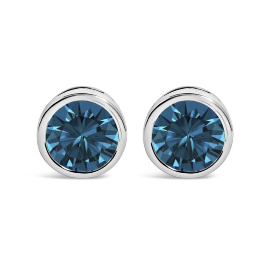 Pair of white metal round bezel-set earrings with blue gemstones, shown in a front-facing close-up view.
