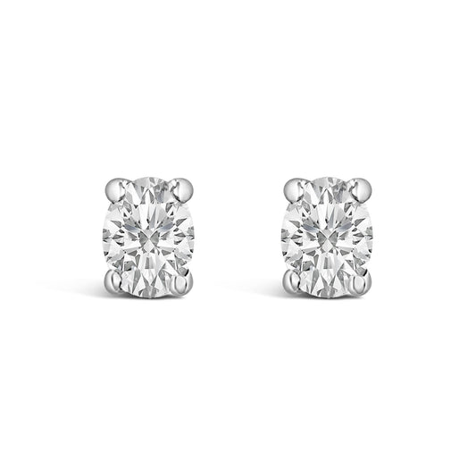 Close-up front view of white metal stud earrings with oval-shaped white gemstones in four-prong settings, shown on a white background.