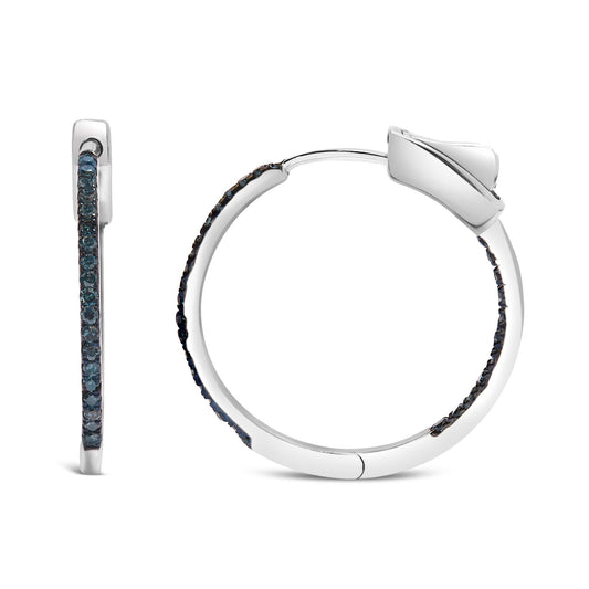 Pair of white metal hoop earrings with round blue gemstones in prong setting, shown from front and side angles on white background.