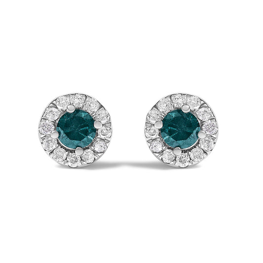 Front-facing close-up of a pair of white metal round stud earrings featuring a central blue gemstone in a four-prong setting, surrounded by a halo of smaller white gemstones in prong settings.